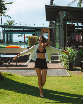 Happy woman on lawn in exotic resort