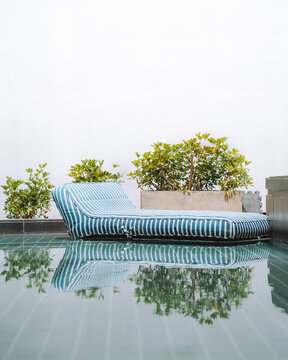 Inflatable mattress floating in pool water