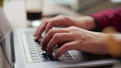 Close up of freelancer's developer hands typing program code on laptop keyboard in coworking. Businessman at work in working in office. Copywriter writing text on computer keyboard in coffeeshop.