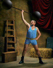 Strength. Overweight man, retro circus strongman wearing striped sports swimsuit with barbell over...