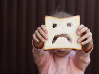 diet celiac gluten free sad bread in the hands of a child	
