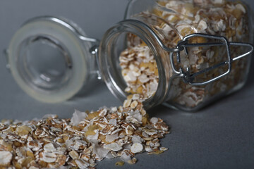 glass can of oatmeal isolated on gray background
