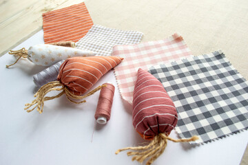 Easter needlework, sewing tools, thread,  fabric carrots, decor for decorating the house for Easter.