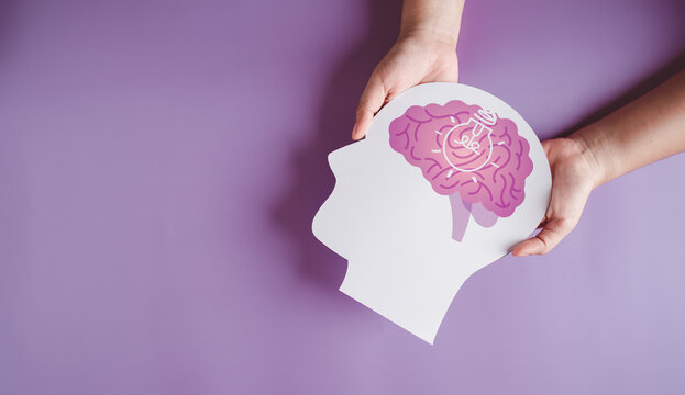 hands holding brain with light bulb paper cut, innovation idea creative, autism, Stroke, Epilepsy and alzheimer awareness, seizure disorder, stroke, ADHD, world mental health day