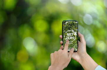 Businessman hands concept net zero icon on mobile screen environmental conservation in ECO...