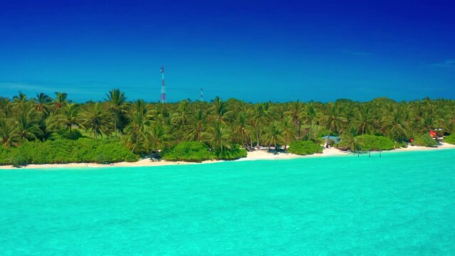 Tropical beach in Thoddoo island with palm trees, white sand and blue sea, perfect summer vacation landscape or holiday. Beautiful tourist destination, Maldives