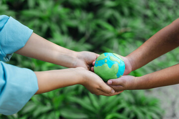 two people holding a globe green earth environmental conservation concept earth day on green bokeh background protect the environment and sustainability, save the world, the world, the world