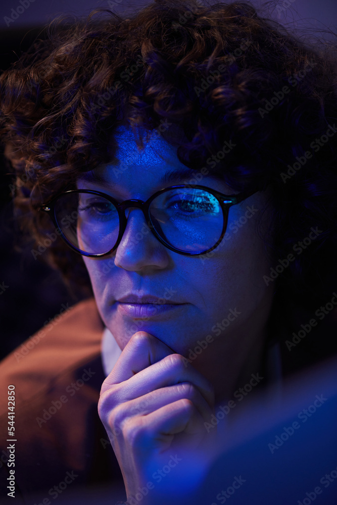Aufkleber young busineswoman with pensive facial expression sitting in front of computer and looking at screen