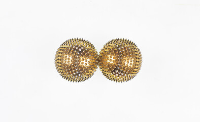 golden massage balls with spikes isolated on white background