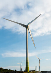 Close-up of wind power systems with the blue sky background.