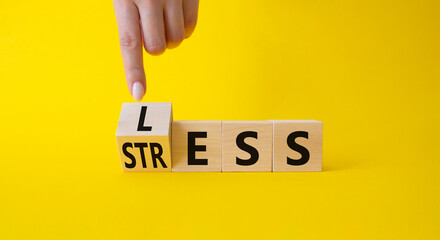 Less Stress symbol. Doctor points at wooden cube with words Less Stress. Beautiful blue background....