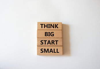 Think big start small symbol. Concept words Think big start small on wooden blocks. Beautiful white...