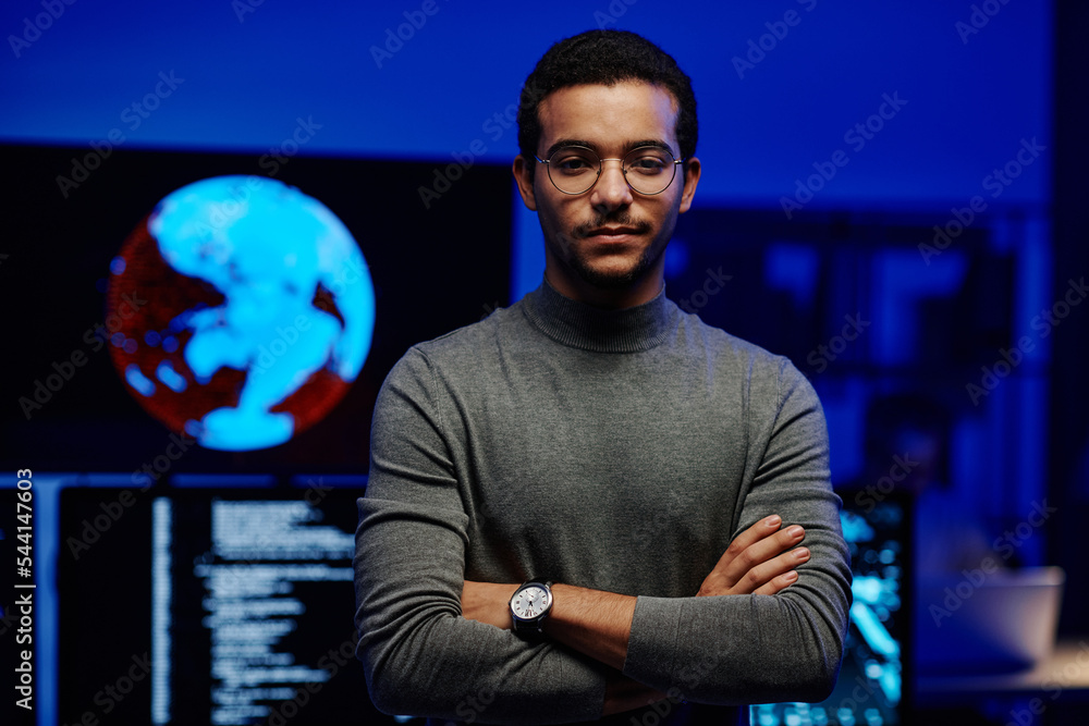 Poster young modern programmer of huge it company or corporation keeping his arms crossed on chest while lo
