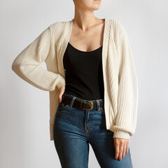 Woman wearing light sweater and blue jeans isolated on white background