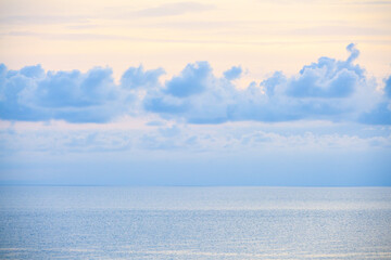 Fototapeta premium Blue clouds on the calm sea