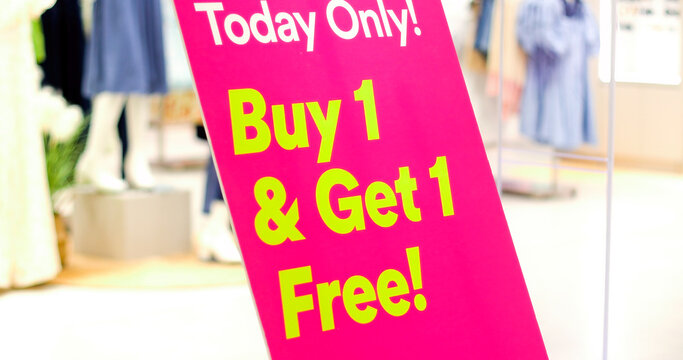 Bright sign with Buy 1 Get 1 Free sale promotion in shopping mall