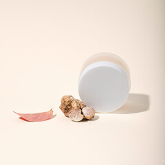  Natural cosmetics, cream with white truffle   extract on a pink background. White truffle extract full of antioxidants and vitamins, anti-aging and skin rejuvenating, conceptual still life