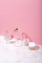  Natural cosmetics (serum, cream) with white truffle   extract on a pink background. White truffle extract full of antioxidants and vitamins, anti-aging and skin rejuvenating, conceptual still life