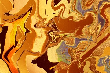 Abstract background of yellow-brown marble. Acrylic paint spreads freely and creates an interesting pattern. Background for the cover of a laptop, notebook.