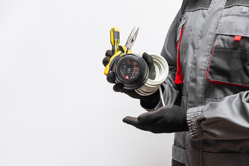 CCTV security camera and work tools in the hands close up isolated on the white background.