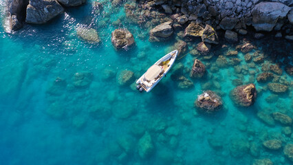 Aerial drone photo of small inflatable rib speedboat anchored in beautiful bay of small fishing...