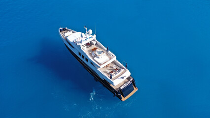 Aerial drone photo of large luxury yacht anchored in paradise Mediterranean bay with turquoise crystal clear sea