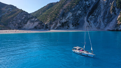 Aerial drone photo of sail boat anchored in paradise beach of Myrtos with crystal clear turquoise...