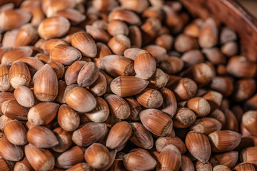 Close up on a pile of Hazelnuts in a wooden bowl