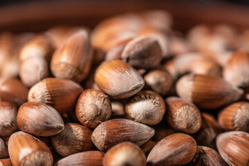 Macro Close up on a pile of hazelnuts with a beautiful depth of field in a brown bowl