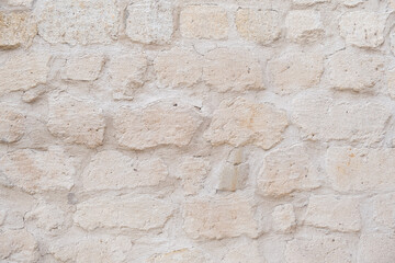 Detailed textured background of sandstone old wall with blocks light yellow colored texture