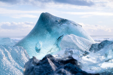 Diamond beach, Iceland. Pieces of icebergs with clear ice. Reflections and light in the ice during...