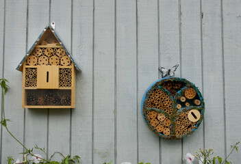 arts and crafts style insect hotel hanging in the garden