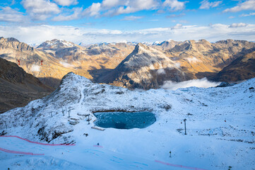 Small turquoise colored lake surrounded by fresh snow near Refuge Diavolezza in the Bernina...