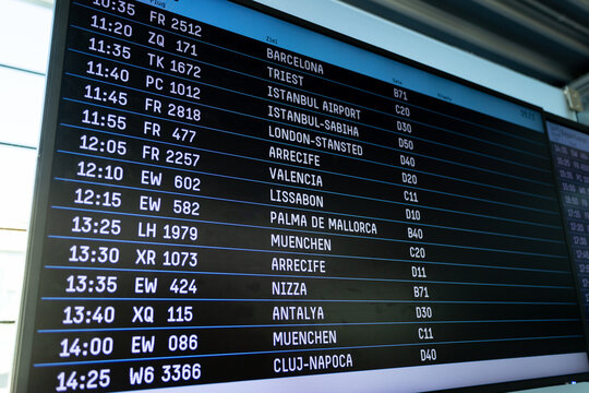 Flight Schedule Information Board Inside An Airport. Screen Panel With Names Of Cities And Codes Of Numbers And Letters.