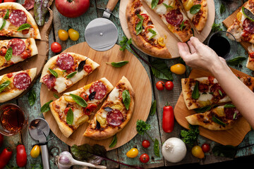 Tomatoes pizza party, woman hand hold the pizza piece