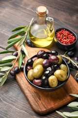 Mixed green olives and black olives with olive oil, healthy eating antioxidants