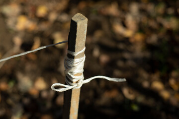 Rope on stick. Ground marking. Rope wound on board. Earth measurement by filament.