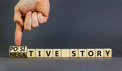 Positive or negative story symbol. Businessman turns cubes, changes concept words Negative story to Positive story. Beautiful grey background. Business positive negative story concept. Copy space. © Dzmitry