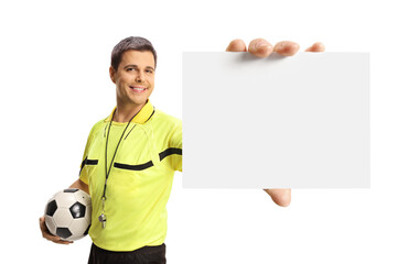 Football referee holding a ball and a blank card