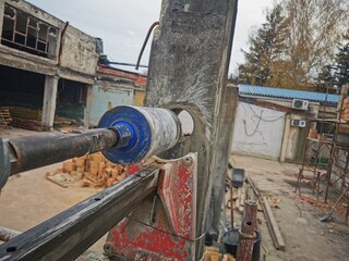 Hole cutting machine. Drilling concrete with an industrial drilling machine with an industrial diamond grain. Core drills used in ring cutters for reinforced concrete columns