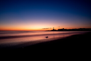 Sunrise view of the lighthouse and town of Cabo de Palos, in Cartagena, Spain