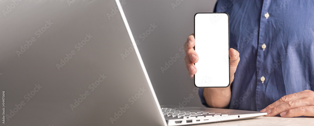 Poster Hands with phone screen mockup and laptop. Promo business banner with copy space for text and smartphone display for app ad