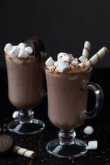 chocolate ice cream.coffee with marshmallows and wafer stick. Delicious Hot Viennese Coffee In Glass Cup With Whipped Cream.Winter and autumn time. Christmas drink on the black background. copy space.