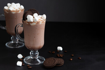 coffee and chocolate with marshmallows and cookies. Delicious Hot Viennese Coffee In Glass Cup With Whipped Cream.Winter and autumn time. Christmas drink on the black background. copy space.