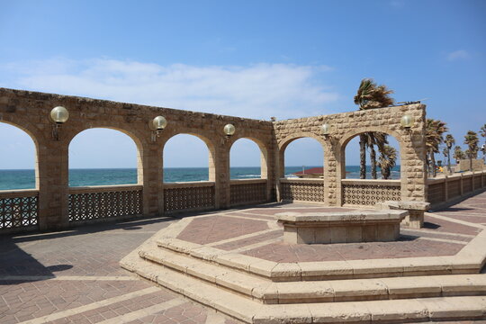 view from the boardwalk of Givat Aliya Promenade near the Arches Beach on the seafront in Jaffa at israel under blue sky