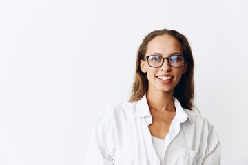 Happy woman with tanned skin having fun at home in a white top and white shirt with glasses against a white wall, lifestyle