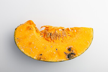 a rotted, moldy, overdue and pumpkin slice