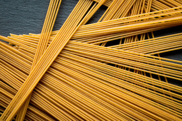 Italian spaghetti on a black slate stone background with space for your text. concept. geometry. food. style