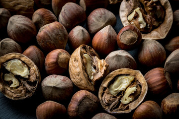 different nuts on a dark background. ripe nuts.  nuts in the shell