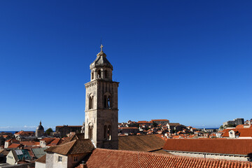 Fototapeta na wymiar slim tower above the Dominican Monastery with classic red tiled rooftops inside the old town of Dubrovnik, Croatia 